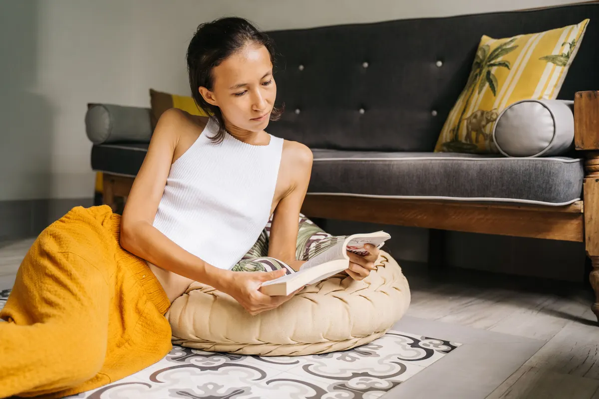 Person lounging on a large floor cushion, the idea behind a human dog bed